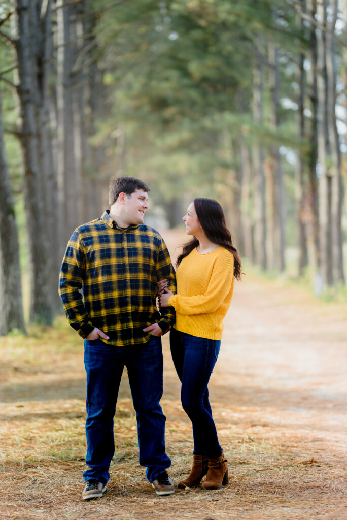 This couple is wearing a yellow and plaid outfit posing on their fall mini sessions richmond VA.